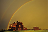 Rainbow over old barn, near Ponteix