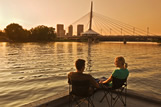 Couple on dock with Winnipeg skyline in the background
